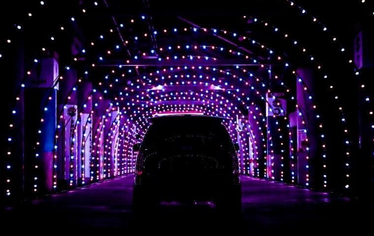 SUV driving through holiday lights